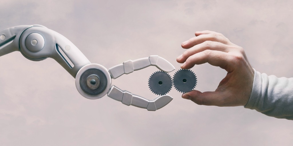 robot-and-human-hand-with-gears-picture-id1220591821 ai can be applied to compliance initiatives in financial firms