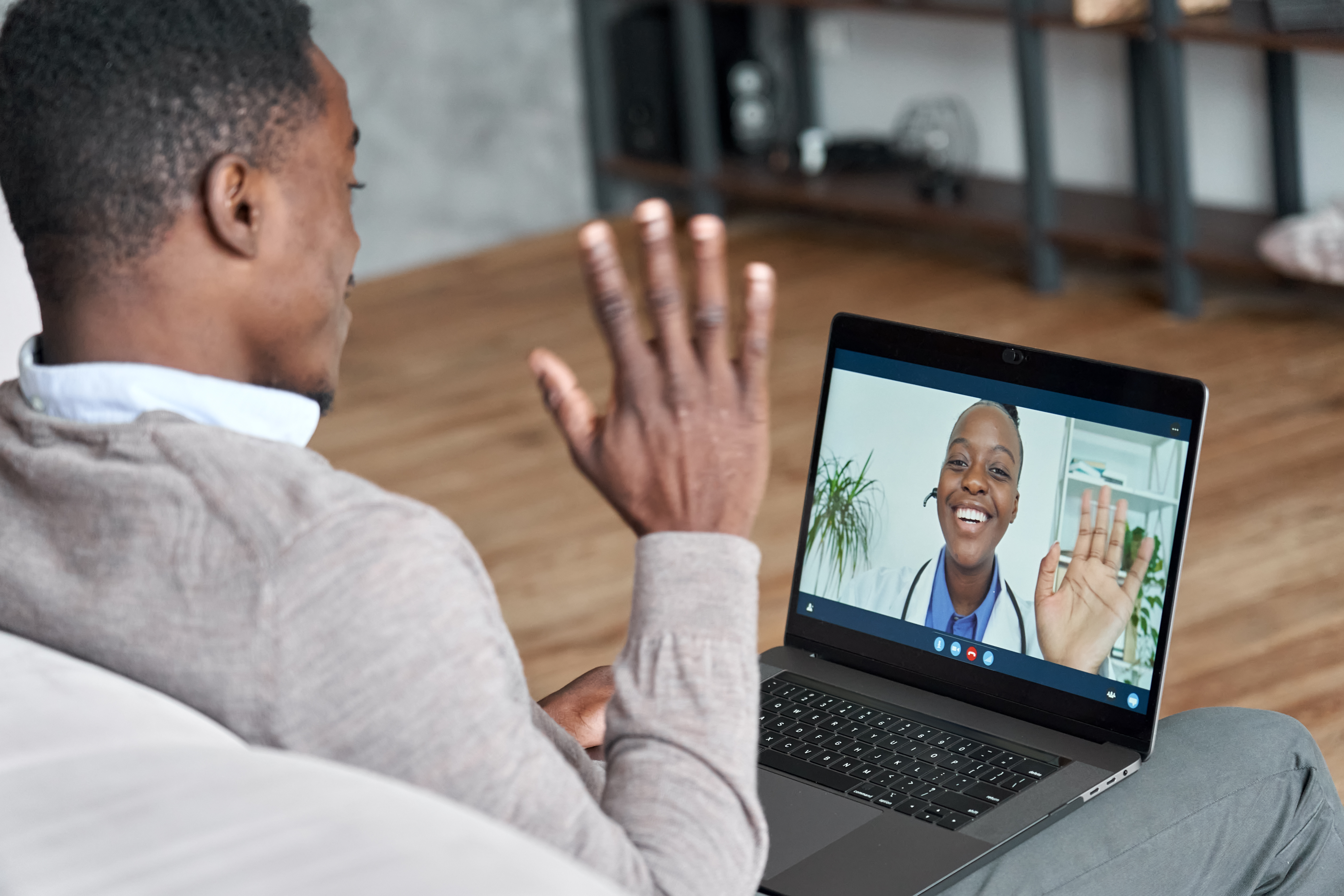Male black patient talking on conference video call to female african doctor. Virtual therapist consulting young man during online appointment on laptop at home. Telemedicine chat, telehealth meeting Telehealth