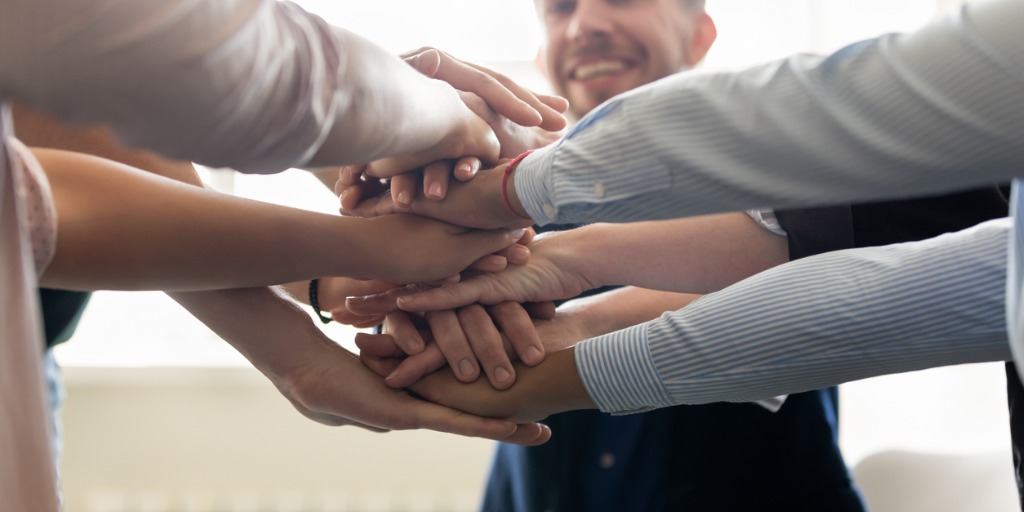 successful-staff-stacked-hands-together-celebrating-successful-work-picture-id1201798734